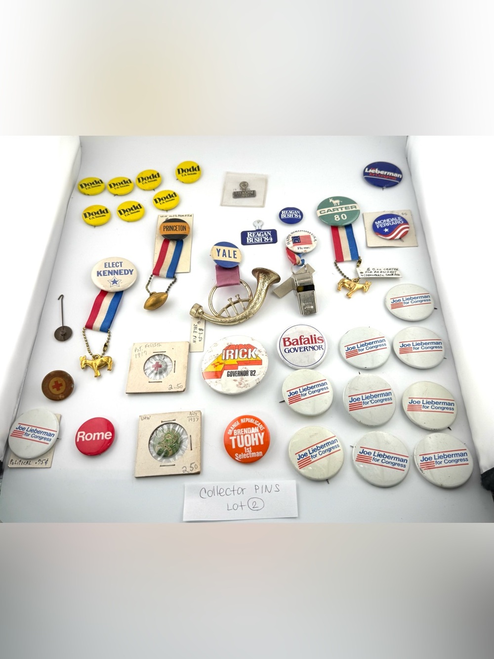 Vintage political campaign buttons, pins, and historical memorabilia.